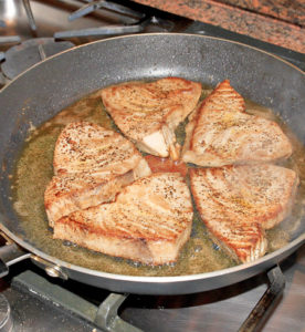 tuna steak being pan fried