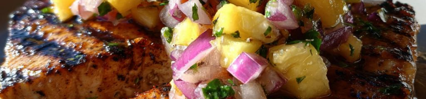 City Fish Market swordfish steaks, grilled with a smoky spice rub and topped with a charred pineapple-jalapeno salsa.